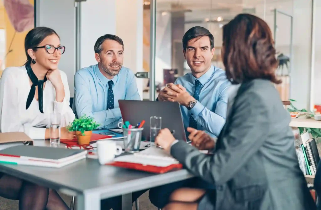 Senior leaders around a conference table talking about strategy.